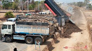 Amazing dump truck unloading gravel stones building road foundation with Komatsu d61p dozer pushing