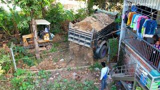 Bulldozer Komatsu D20 Working With Dump truck Filling At Narrow