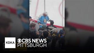 Penguins fan ejected after swiping puck from young fan