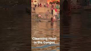 Man cleansing in the Ganges River in Varanasi, India.