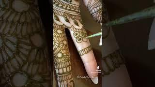 Why do brides hide the grooms name in their mehndi?