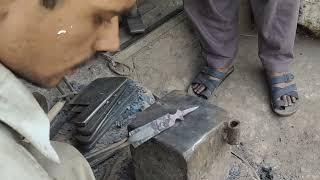 blacksmith (lohar) making a beautiful wood chisel from a rusty spring leaf. handcraft, hand made .