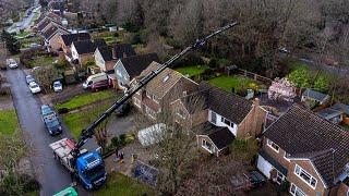 Drone footage of a heavy-duty Crane lifting beams over a Property