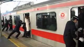 People stuffed onto a train in Tokyo, Japan (train stuffing Tokyo)