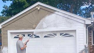 Foam cannon on a house pressure washing and painting job