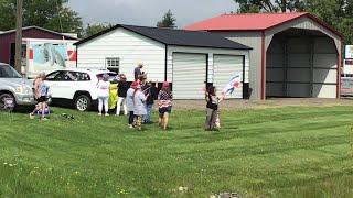 Supporters await former President Donald Trump's motorcade in Potterville