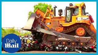 Moment bulldozer crushes illegal dirt bikes  over and over again in New York