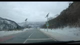 Scenic drive through snowstorm in alpine valley towards lake Bohinj - Relaxing ambient music