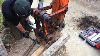 Abandoned digger gets new bucket/hitch pins and widens a narrow trail.