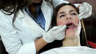 Girl at the dentist gets a dental scraping by an evil dentist