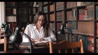 Girl Reading Book in Library (Stock Footage)