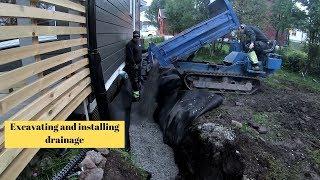 Excavating and installing drainage on house