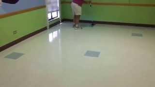 Floor Doctor using the microfiber mop to apply wax