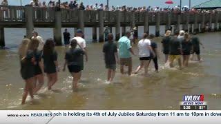 Local church holds public baptism on the beach in Ocean Springs