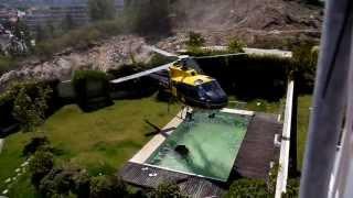 Amazing helicopter pilot taking water from swimming pool