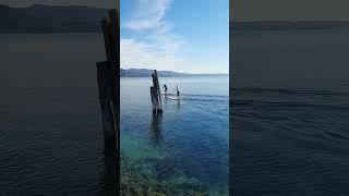 Stand up paddlers enjoy the view - Garda, Lake Garda, Italy