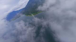 FPV Drone flying through clouds in the mountains