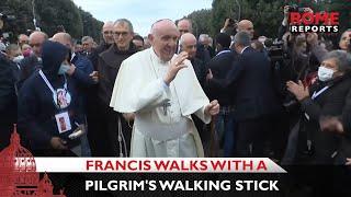 Pope Francis walks through Assisi with a pilgrim's walking stick