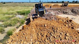 Powerful SHANTUI DH17C3 Dozer techniques pushing soil filling level huge land with 25ton dump trucks