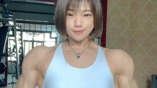 Beautiful muscular woman flexing muscle