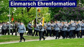 Torches and marching music: German army  honour formation carries their flag to the parade ground