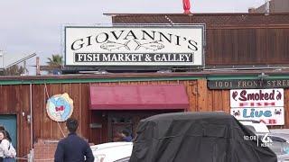 Community members protest outside of Giovanni's Fish Market following owner's not-guilty plead