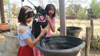 Rural Burma - Girls Pulling Water Out From Well