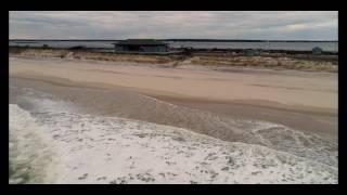 Rough seas crashing against windy winter beach.