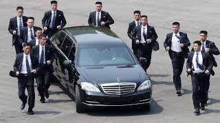 Kim Jong-un's bodyguards jog alongside limo