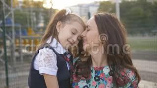 School Daughter and Mother Kissing on Lips