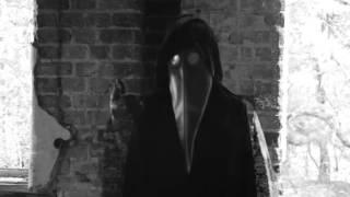 creepy evil cryptic video - person in plague mask communicating some cryptic message