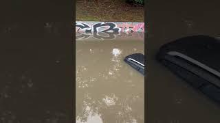 Cars are submerged in street after storm in Warsaw, Poland