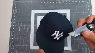 Cutting open the New York Yankee Hat