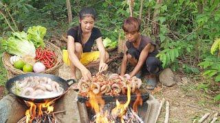 Pork intestine hot spicy chili grilled on the rock for delicious food, Survival cooking