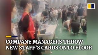 Chinese company managers throw new staff’s cards onto floor