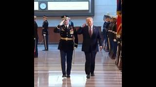 Trump reviews military troops before heading to arena