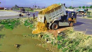 Nicely Project,Showing Action Machinery Working, Land filling,Bulldozer KOMATSU D31P,Truck unloading