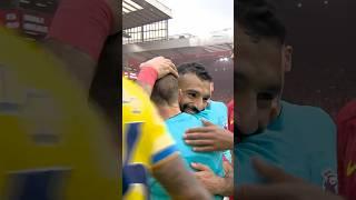 Mohamed Salah embraces retiring offical Derek Eaton as he hangs up the whistle 