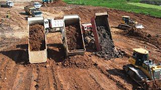 Ten Wheel Dump Truck Pouring Sticky Soil - Bulldozer Push In To Water