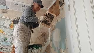 #2 Decoupaging kitchen walls with historic newspapers, magazines and travel items left in home.