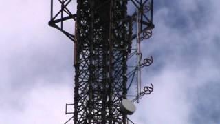 Tubular lattice tower erected on existing building