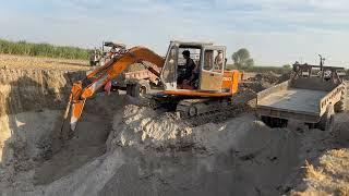 Power Moves: Excavator Loading Mud into Trailer in Action!"