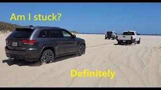 Jeeps stuck, Toyotas stuck, and a Land Rover stuck at the beach.