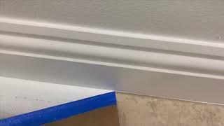 Spraying baseboards with Emerald Urethane Trim Enamel