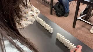 Visualizing wave speed in liquids, semi-solids, and solids using Dominoes