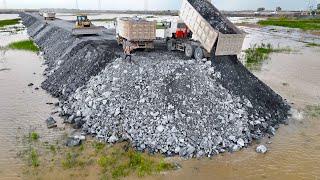 Construction Road Defining Land Boundaries Use Bulldozer Push Stone and Dump Truck Moving Stone