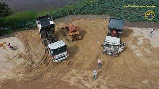 Heavy Machinery Work! Dump truck pours soil And Bulldozer push the soil waterfront