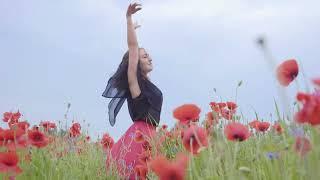 Девушка, счастливо танцующая на поле с цветами