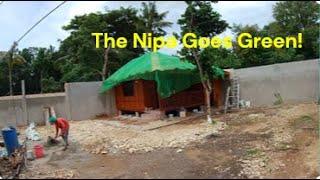 Putting the netting on the nipa roof.