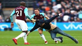 West Ham shame: Furious fans invade pitch in protest against owners as one is wrestled by